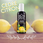 Un flacon de 100 ml de cèdre citron aromaspray avec des citrons jaunes en arrière plan posés sur une table en bois